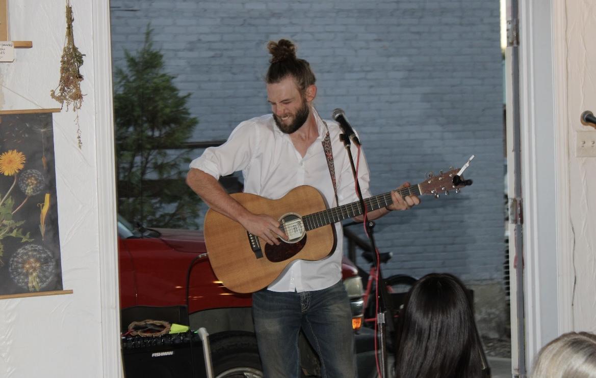 A local performer strums an acoustic guitar. Various local bands performed during Mushrooms and Mocktails.