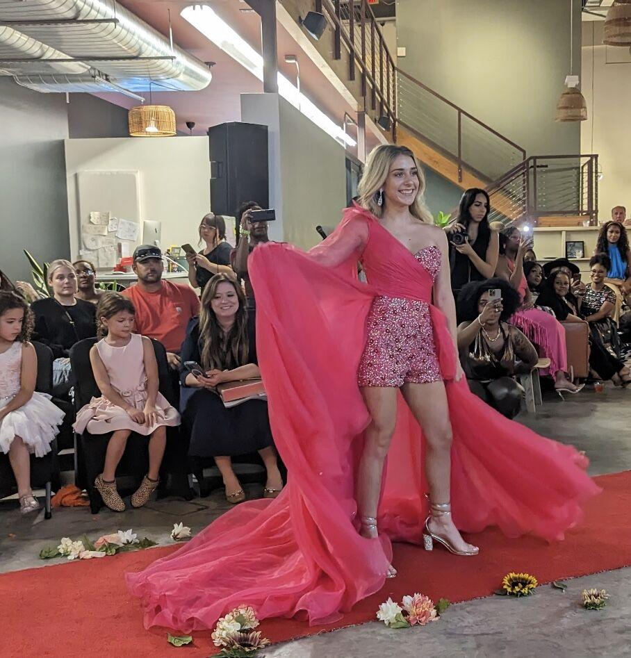 A model pauses at the end of the runway to show off her train. This event kicked off Conway Fashion Week.
 