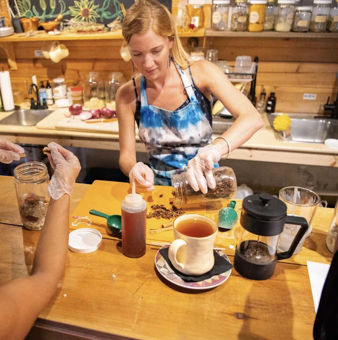 Righteous Remedies' owner, Emily Clark, prepares her ingredients for fire cider.