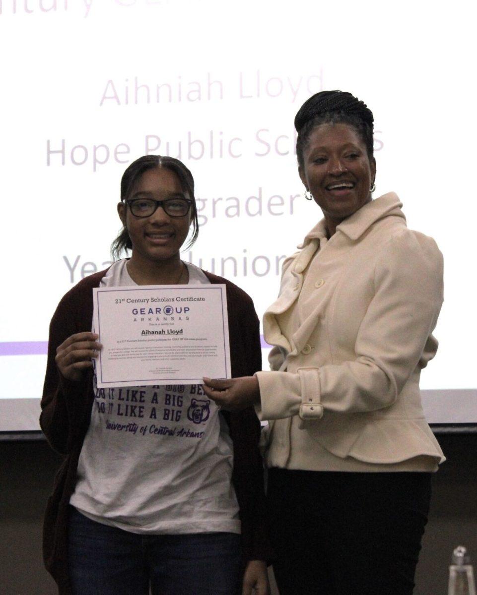 Aihniah Lloyd, a Hope seventh grader, receives a GEAR UP grant certificate from professor Charlotte Parham. UCA was awarded $30 million dollars to increase college preparedness in middle schoolers.