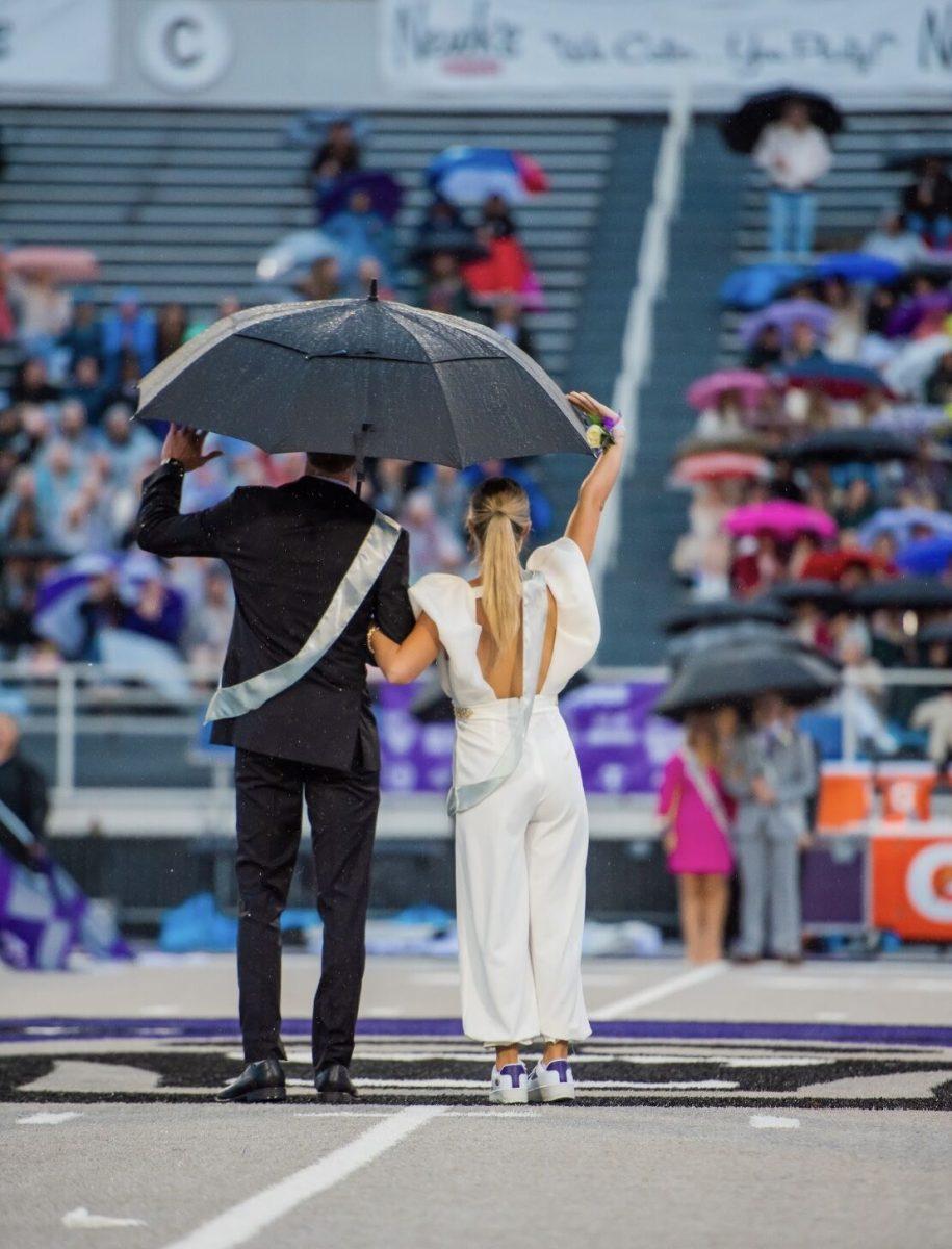 Homecoming princess and senior Mattie Neighbors holds her umbrella during the ceremony.