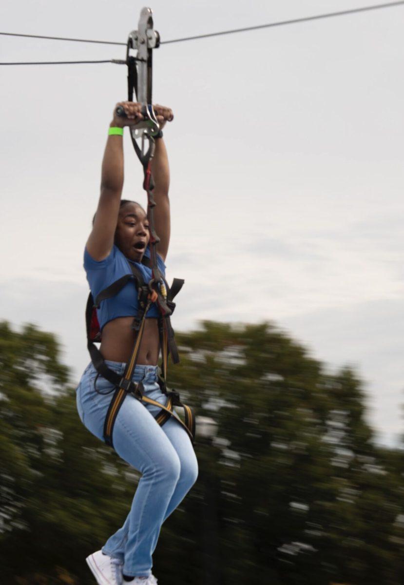  A screaming student zips across the zip line.