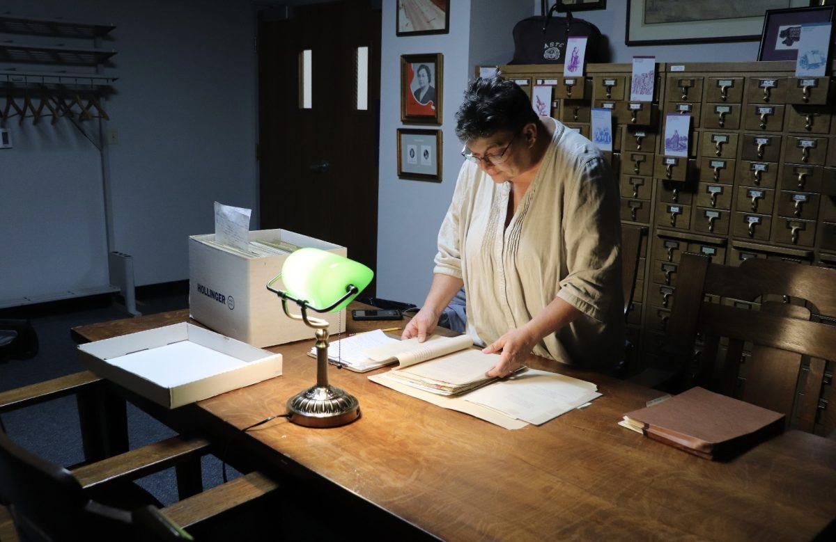 Lynita Langley Ware, director of the Faulkner County Museum, looks through historical documents in the archives. Langley-Ware said she was researching New Deal programs in Faulkner County for a future exhibit.
