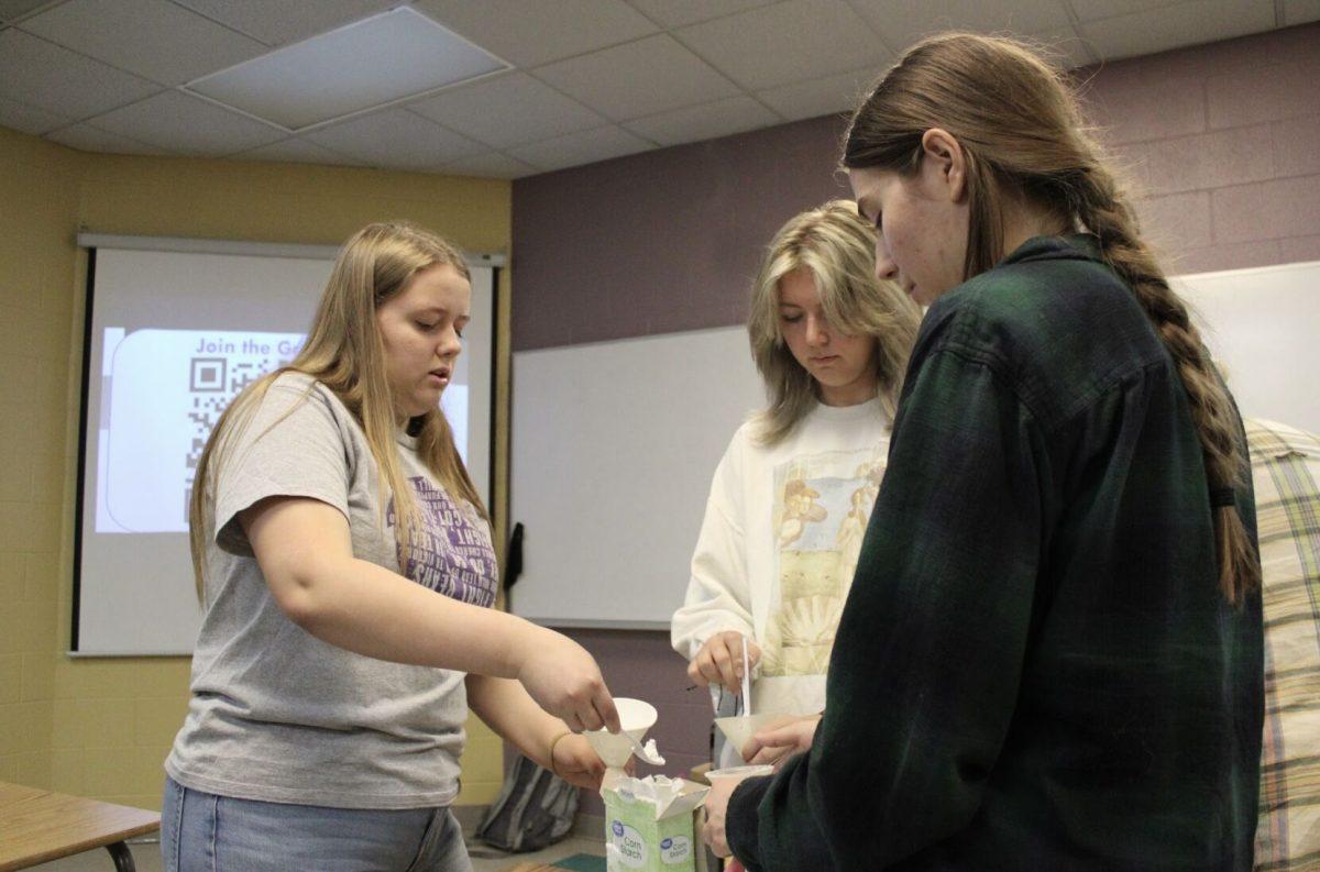 Freshman Hailey Zornes (left) and senior Katherine Peters (right) pour starch into balloons to make stress balls. Students also made bath bombs at the event.
 