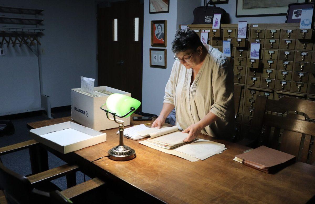 Lynita Langley Ware, director of the Faulkner County Museum, looks through historical documents in the archives. Langley-Ware said she was researching New Deal programs in Faulkner County for a future exhibit.