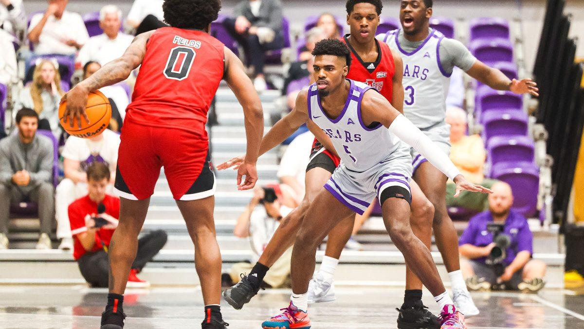 Senior guard Masai Olowokere defends against a Red Wolves player. Olowokere finished the game with two steals, two rebounds and scored two points.