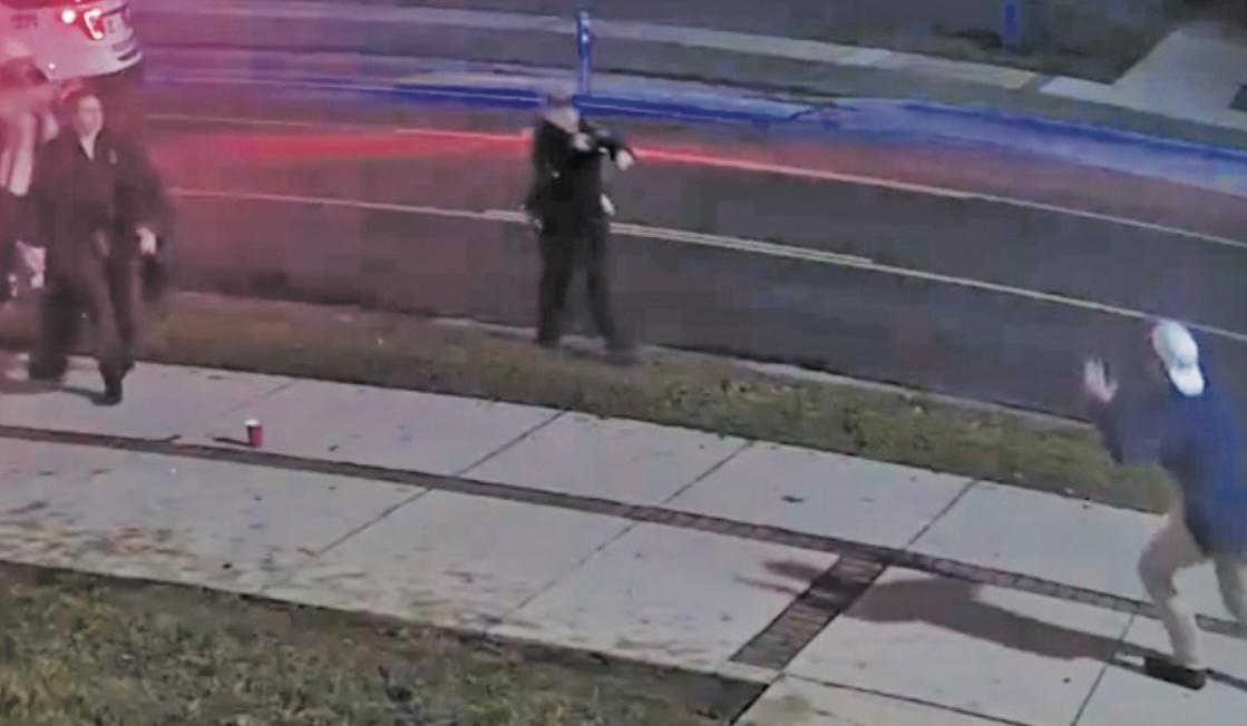 UCAPD Officer Rodney Purvis aims his service pistol at Tyler Stacey, a friend of Darrell Ray Dean's who pulled Dean away from the altercation. Purvis reholstered his pistol after members told him Stacey did not have the knife.