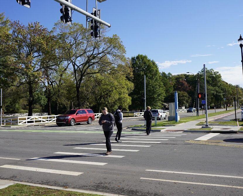 Three students use the crosswalk at Robins Street and Donaghey Avenue. Several students said the walk times feel short.
 