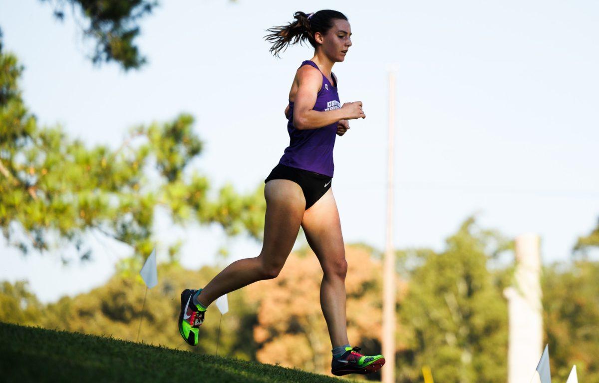 Junior Madeline Hill speeds through the Central Region Championship. Hill finished 36th, with the women's team securing 383 points. 