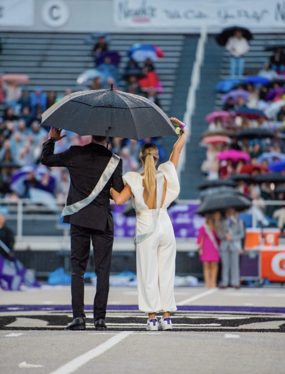 Homecoming princess and senior Mattie Neighbors holds her umbrella during the ceremony.