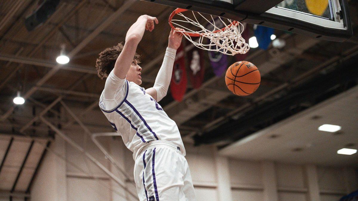 Junior guard Elias Cato dunks on the Red Wolves home court. The Bears lost the match 112-77, in an off season charity match up. All proceeds went to the Wynne Relief and Recovery Center. 