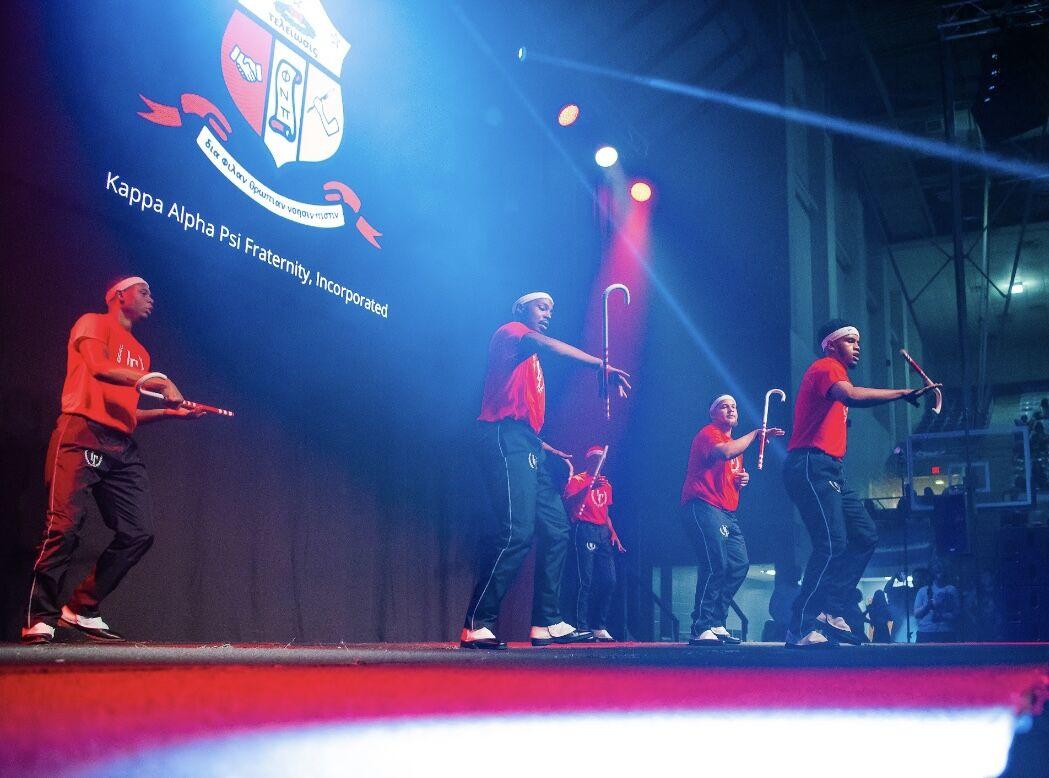 Kappa Alpha Psi members twirl canes.