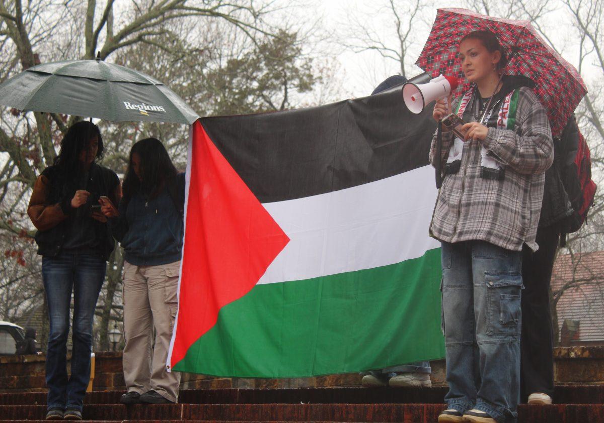 A woman with a megaphone leads student protestors in chanting. Dozens of students attended the walkout Jan. 26, marching and chanting across the Hendrix College campus.