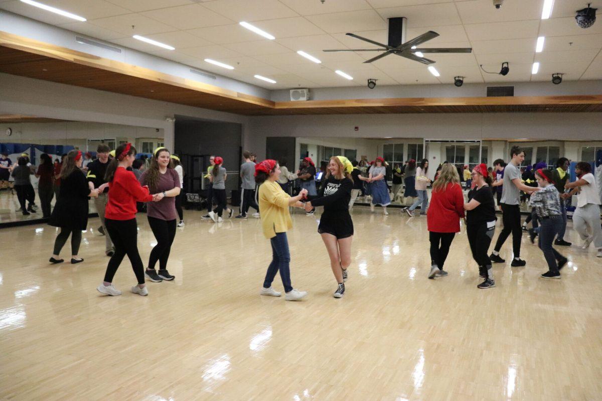 Students wear red or yellow bandanas to identify their roles as cardinals or larks in the contra dance Jan. 26. Attendees learned the choreography while Rob Matson, performing as Bobby Fjsh and the Magic River, freestyled music.