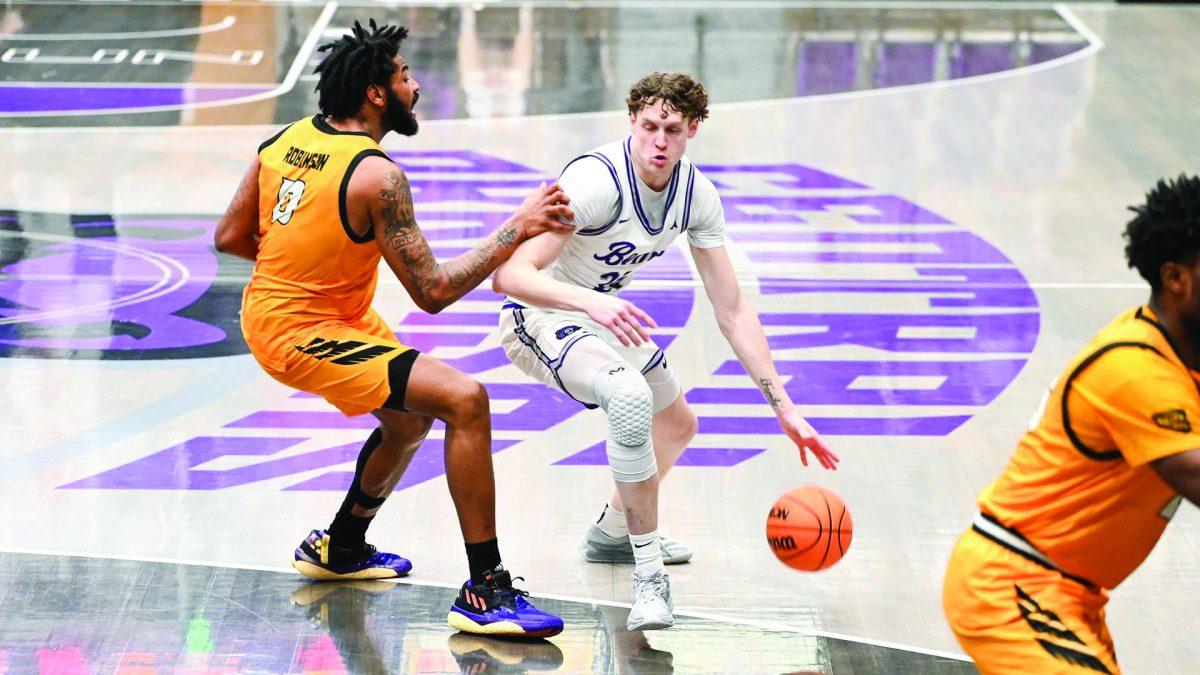 Junior guard/forward Elias Cato pushes past against Kennesaw State player senior forward Demond Robinson. Cato hails from Queensland, Australia.