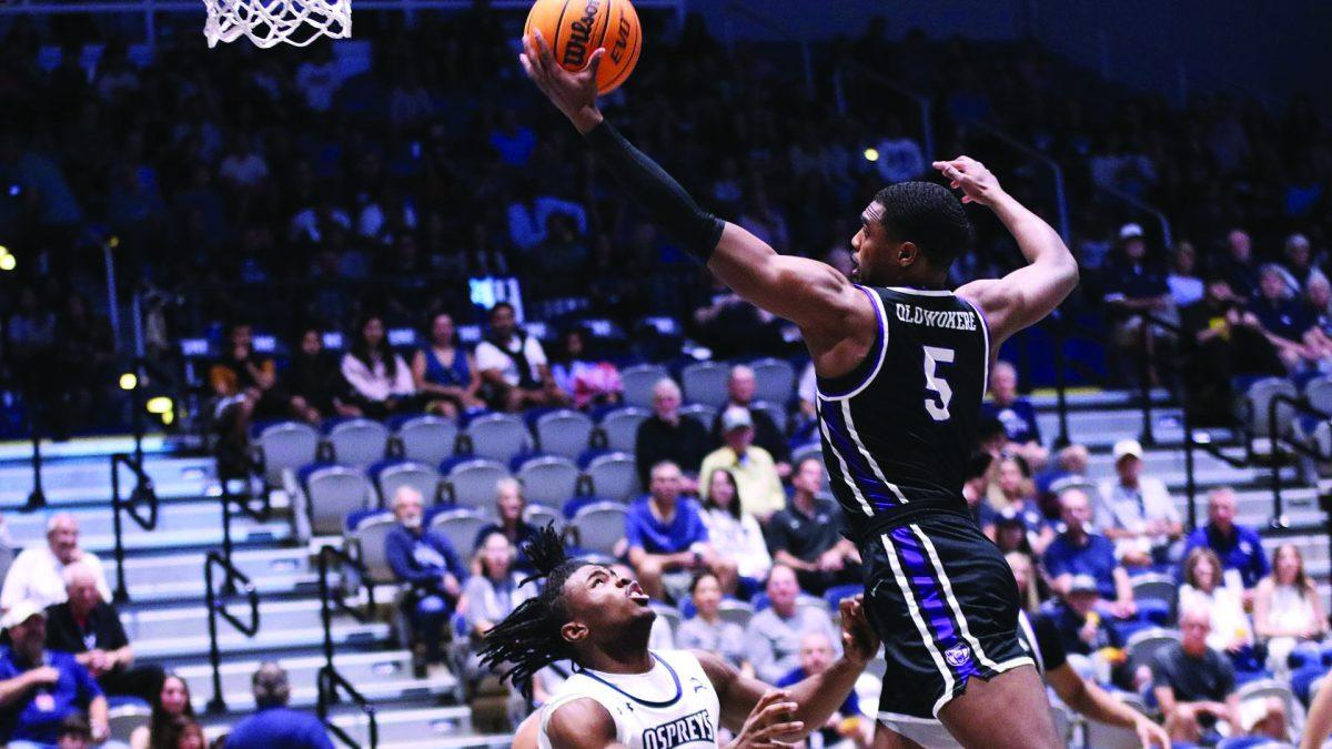 Senior guard Masai Olowokere jumps past a North Florida player in hopes of scoring a lay up. Olowokere has been on court for a total of 742 minutes this season.