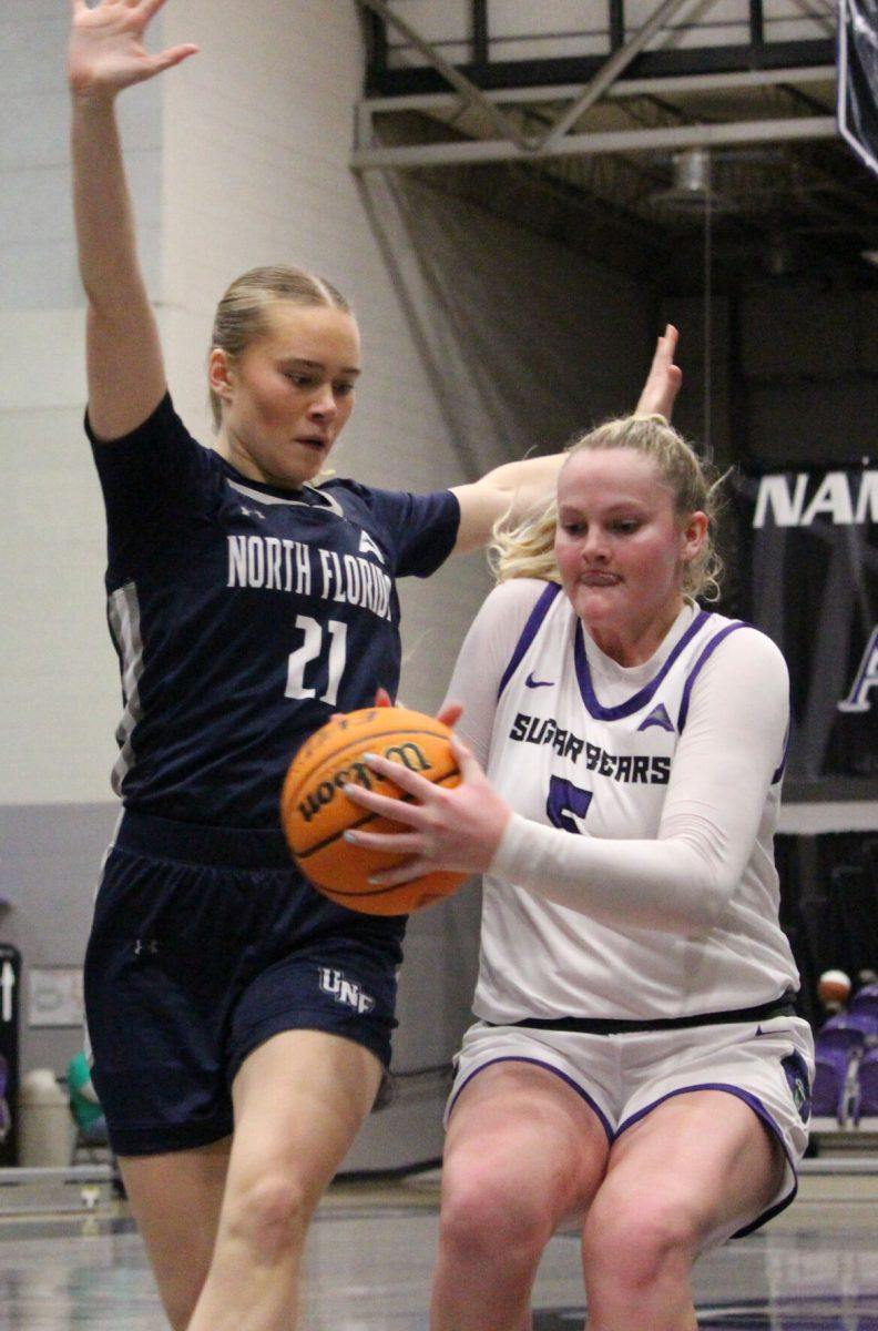 Junior forward Bree Stephens protects the ball from the defender. The Sugar Bears won the game 58-44.