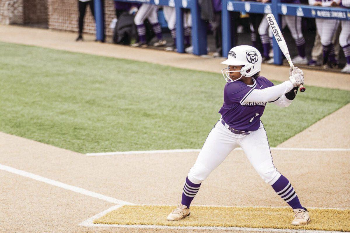 (Top) Senior outfielder Tremere Harris lines up her bat to take a swing.