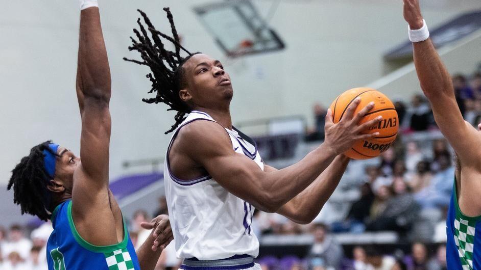 Sophomore guard Carl Daughtery Jr. jumps past two FGCU players to shoot the ball. Daughtery has been on the court a total of 456 minutes so far this season.