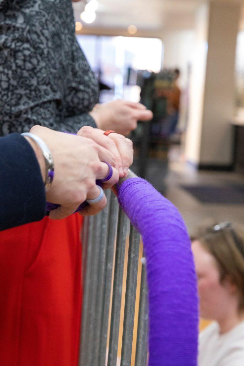 Students and faculty yarn-bomb several spots around campus in preparation for the Dog Barkanalia event.