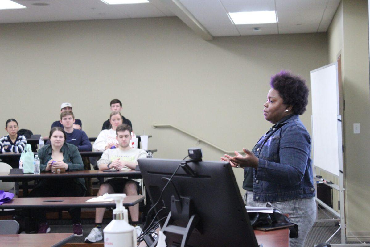 Millie Goins, assistant director of student wellness and programs, presents to students in the College of Business. Goins discussed the importance of both mental and physical wellness.