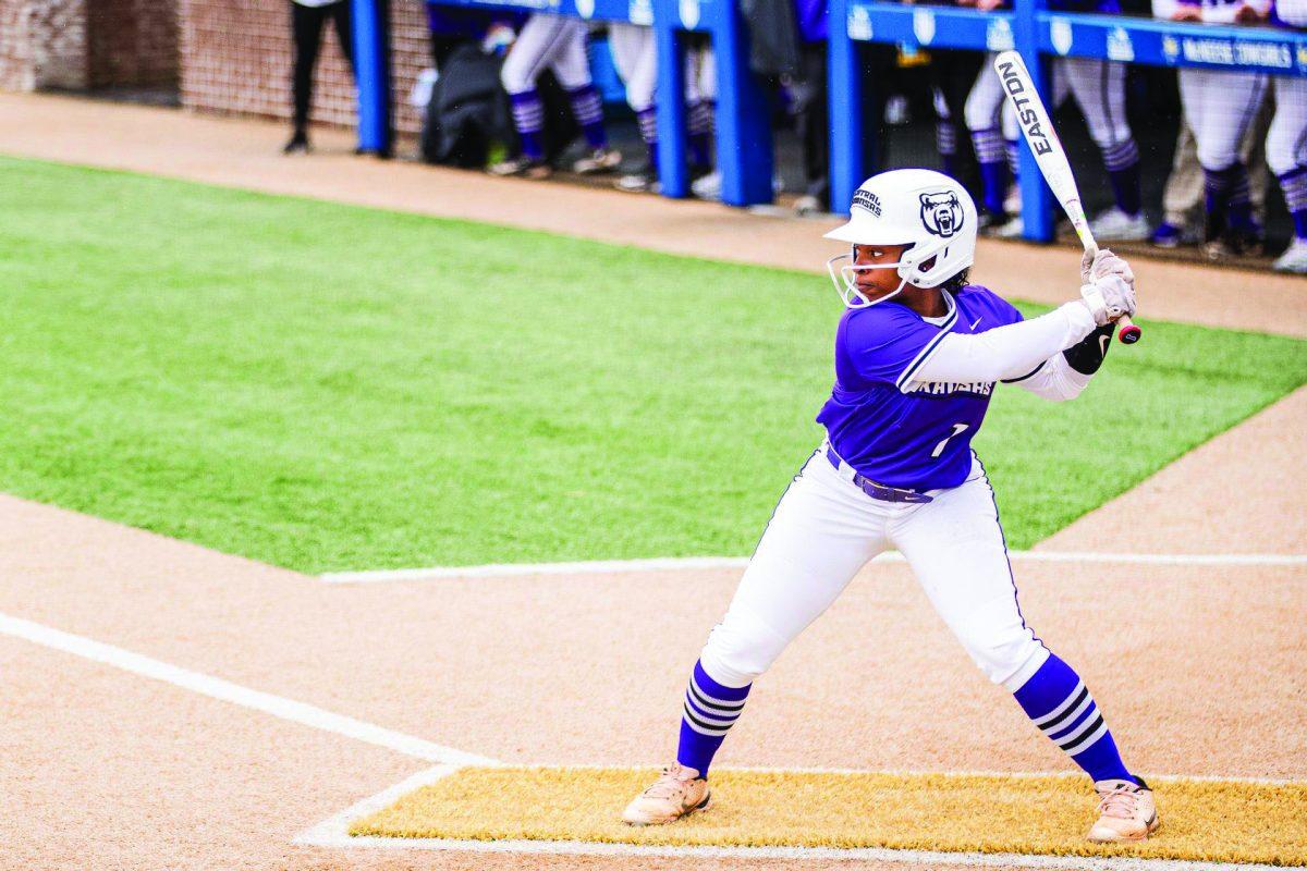 (Top) Senior outfielder Tremere Harris lines up her bat to take a swing.