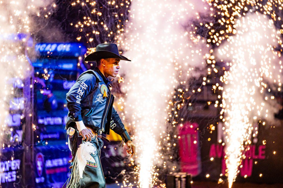 A competing bull rider is showered with sparks as he walks into Simmons Bank Arena. Pyrotechnics livened the crowd at the two-day professional bull riding competition, which was the fifth “Unleash the Beast” event of 2024. 