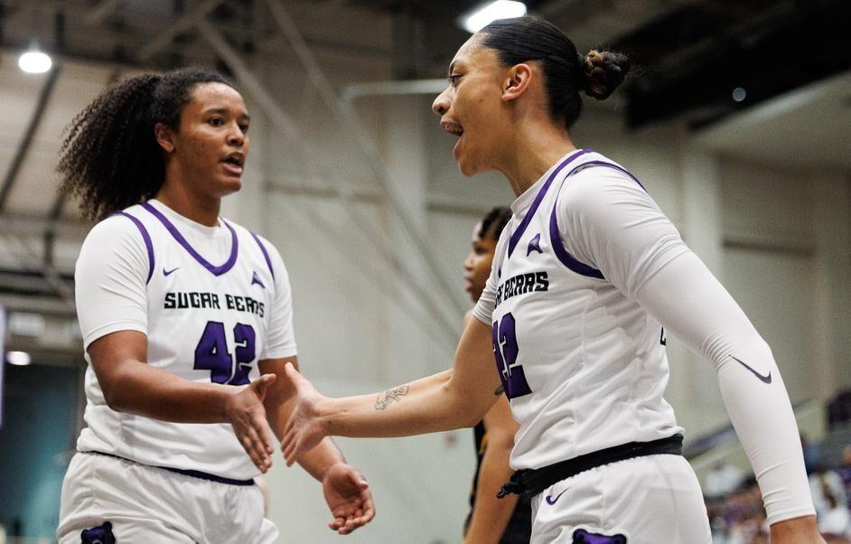 (Left) Junior forward Cheyenne Banks gives (right) junior guard Leah Mafua a high-five.