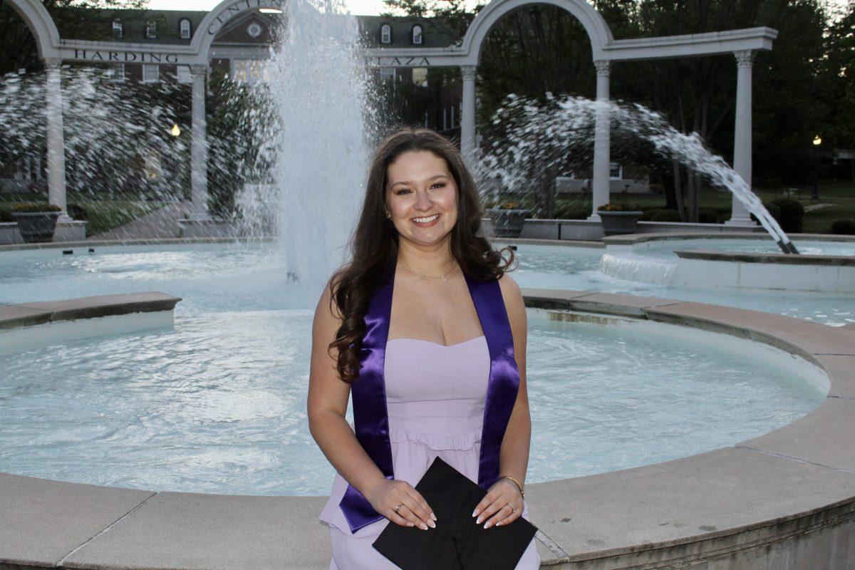 Ashlyn Taylor sits in front of the Harding Centennial Plaza fountain. She won't miss pulling all-nighters to complete homework, but the precious memories made it all worth it. 