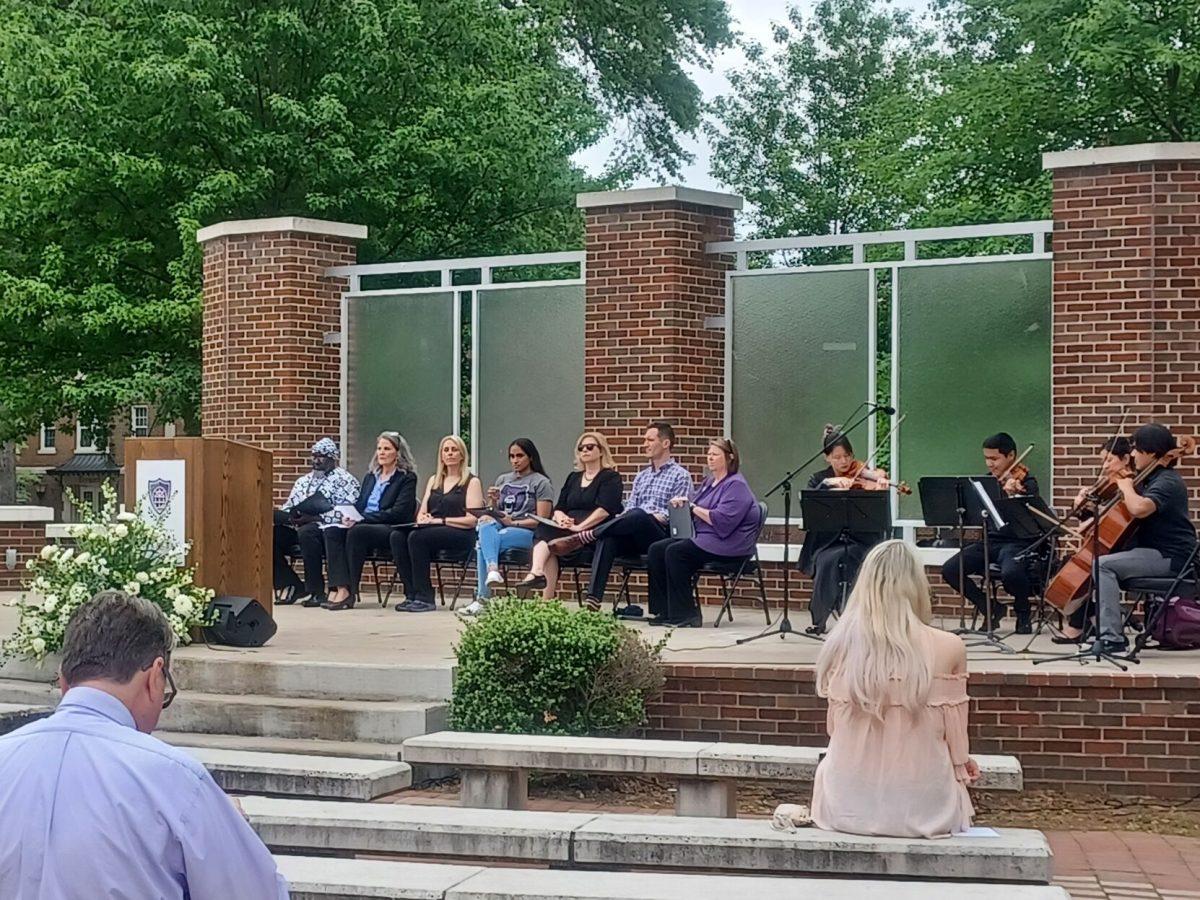 Speakers and attendees at the Forever a Bear memorial service sit in silence as student musicians play on April 18. The service commemorated members of the UCA community that died in the past year.