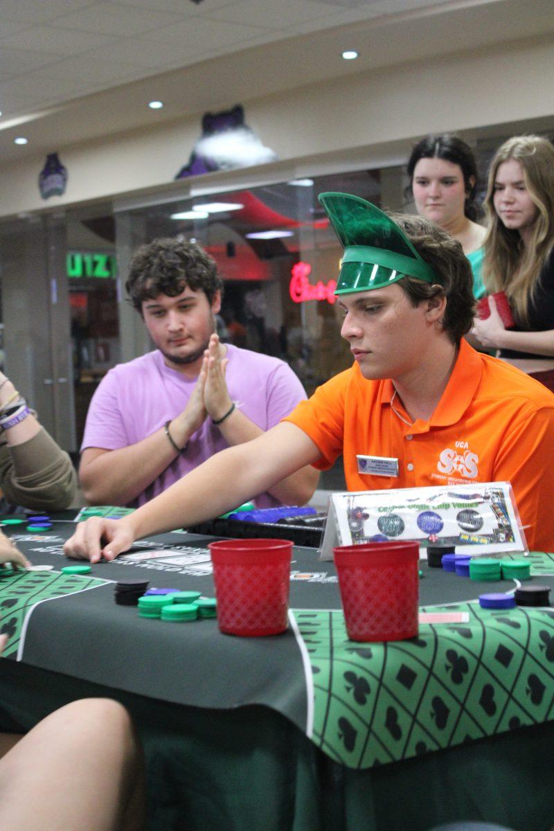 Freshman and a Student Orientation Staff member play poker. Casino night took place Aug. 19 in the Ronnie Williams Student Center.