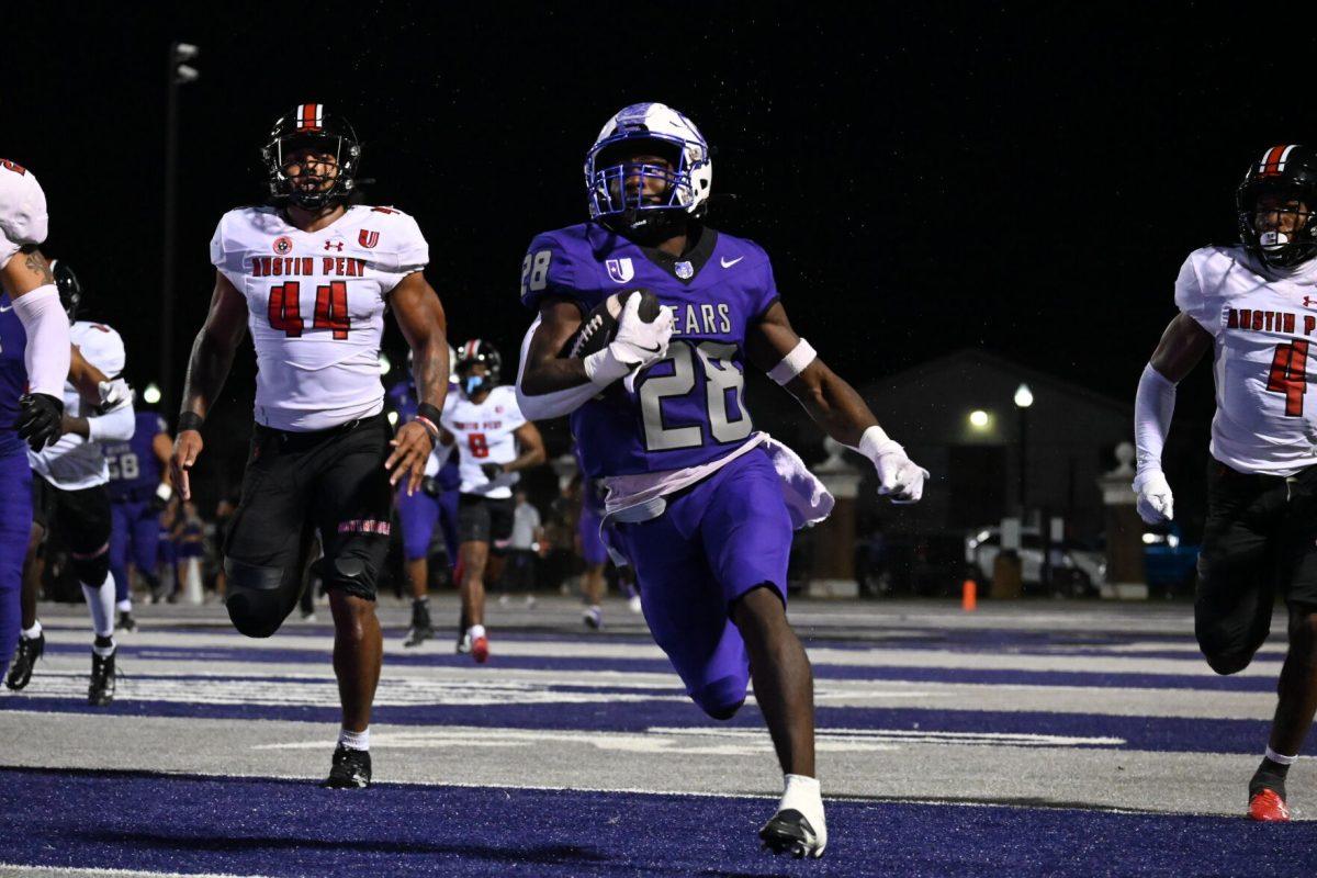 (Middle) UCA sophomore wide receiver Manny Smith runs with the football while being tracked down by (right) senior defensive back Cinque
Williams and (left) graduate student linebacker Dion Hunter. This was Smith’s only reception of the game, which went for 54 yards.