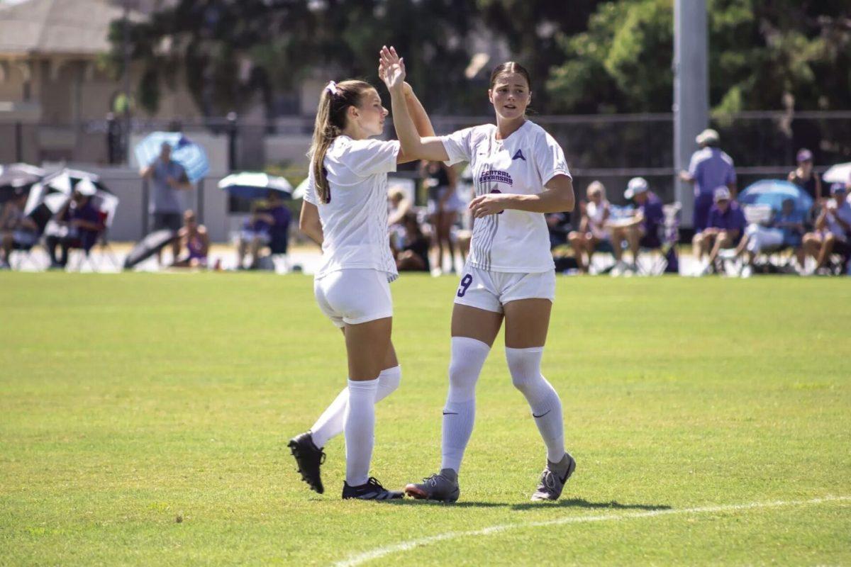 (Left) Junior defender Ava Ronsky exchanges a high five with (right) senior forward Anna Kerr. Dating back to 2013, UCA has defeated University of Louisiana-Monroe eight times in the last 10 matchups. 
(photo courtesy of ucasports.com)