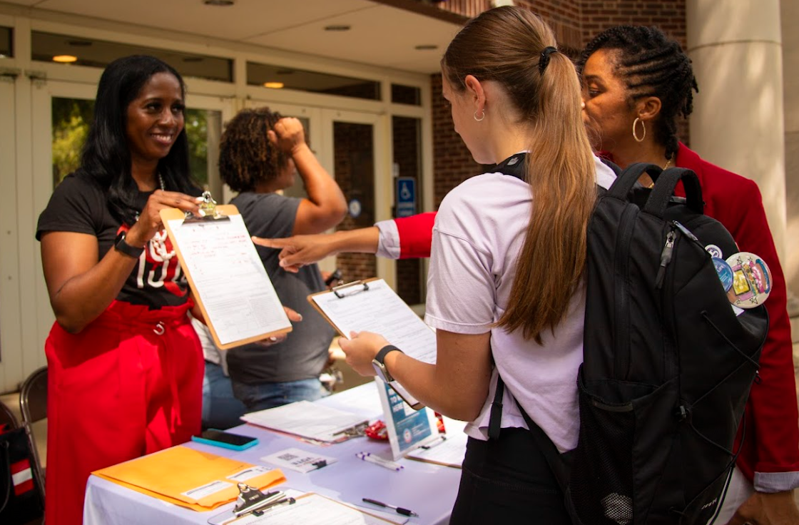 A volunteer aids students in registering to vote. Students from various RSOs volunteered at the Sept. 12 event.