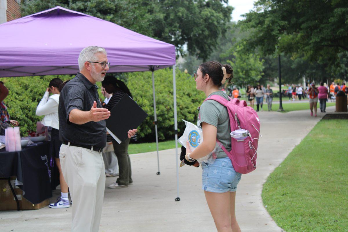 Houston Davis speaks to a student at Lunch on the Lawn on Aug. 19. Davis became UCA president in 2017.