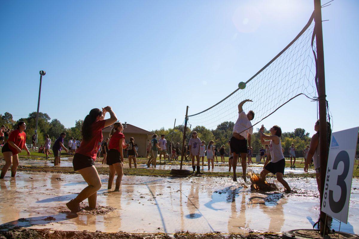 Students volley in a muddy volleyball court at the annual Mudstock tournament hosted by the Association of Future Alumni. 16 teams participated in the tournament Oct. 5.