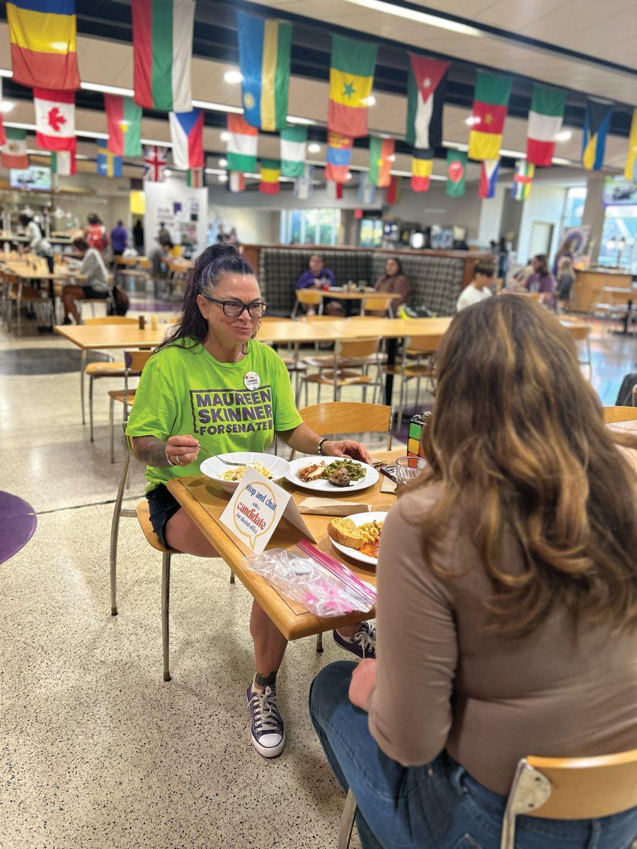 Maureen Skinner, a mental heath professional and small business owner running for State Senate, chats with Hannah junior Smithson at the Christian Cafeteria.