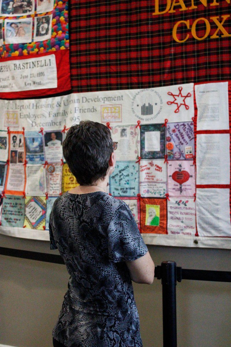 Attendees gazes at the AIDS Memorial Quilt showcased in the Reynolds Performance Hall lobby. The quilt will be in Reynolds until Oct. 11. 