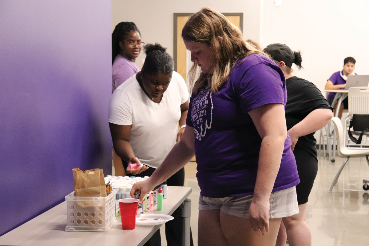 A student chooses paint colors to use during the Oct. 23 event. 