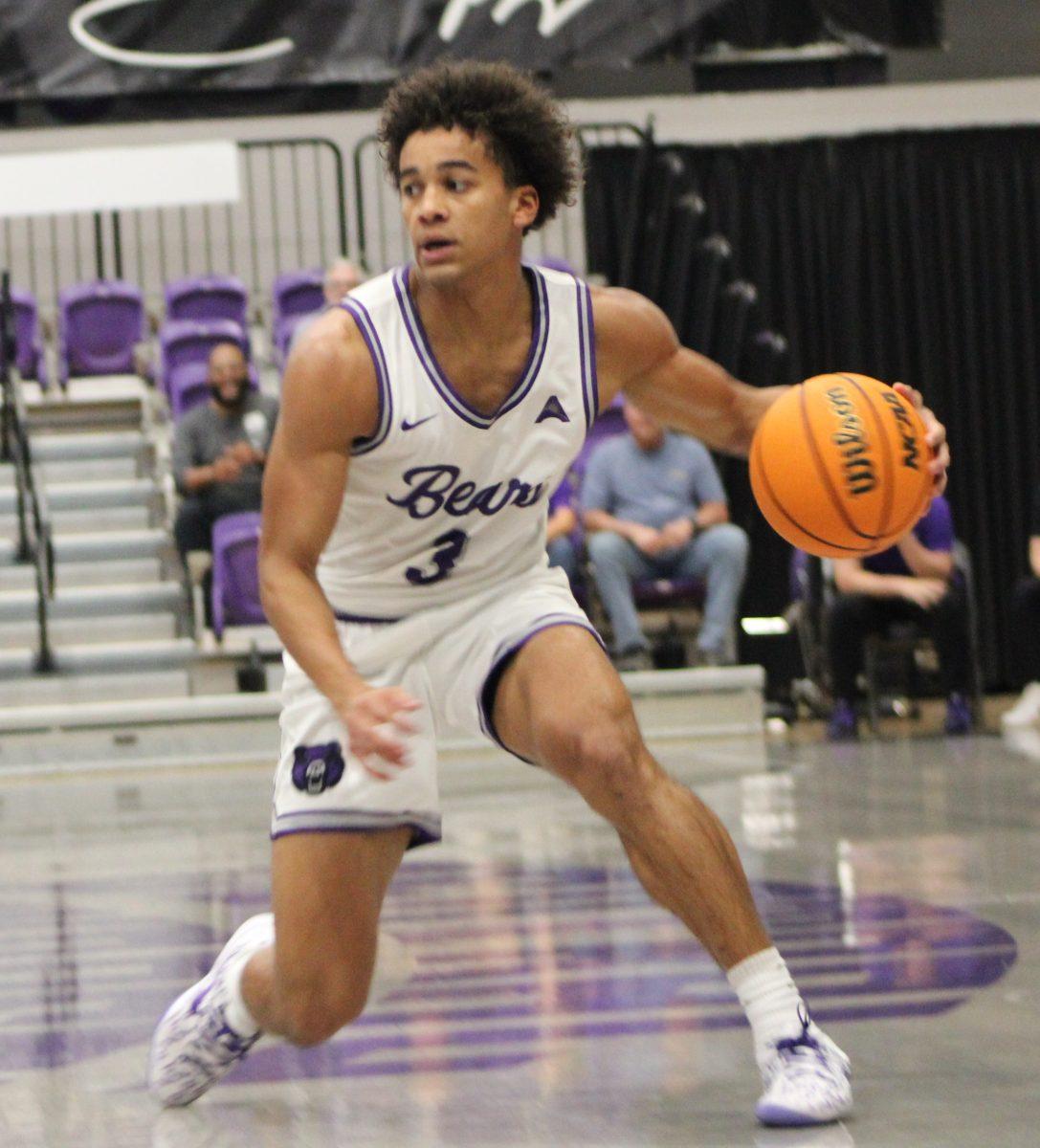 Sophomore Guard Brayden Fagbemi looks for an opening to pass the ball. Fagbemi scored a total of 19 points along side freshman guard Taylor Layne.