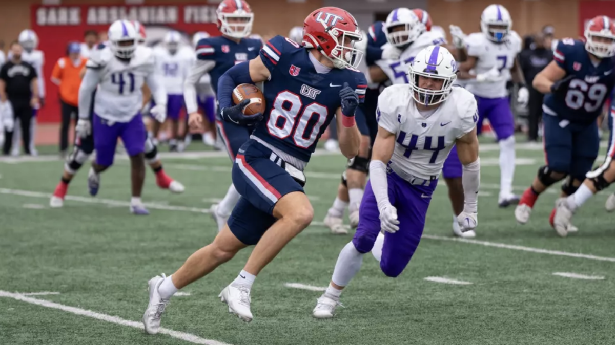 (Top) (right) Junior linebacker Jace Benesch in pursuit of (left) redshirt sophomore tight end Eric Olsen.
(Bottom) Redshirt freshman running back Landen Chambers is drug down by two Trailblazer defenders.