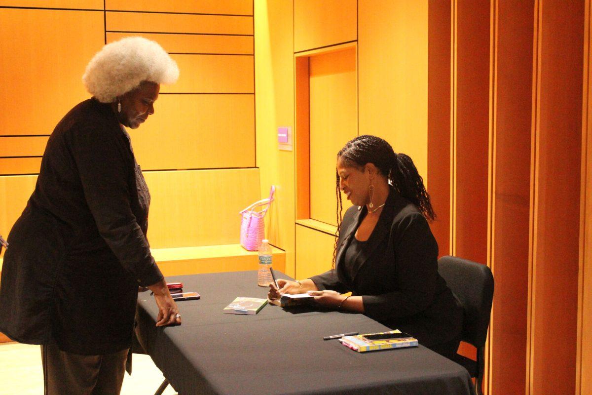 Mecca Jamilah Sullivan signs a copy of her novel “Big Girl” for an attendee. Sullivan’s novel discusses the forbidden desires of the human body.