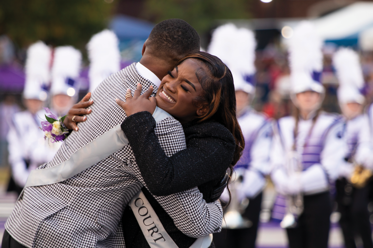 Demetrius Foreman (left) and Kiana Wright (right) hug after Wright is announced as homecoming queen at the Oct. 26 football game. Wright said being elected homecoming queen is one of her proudest moments. 