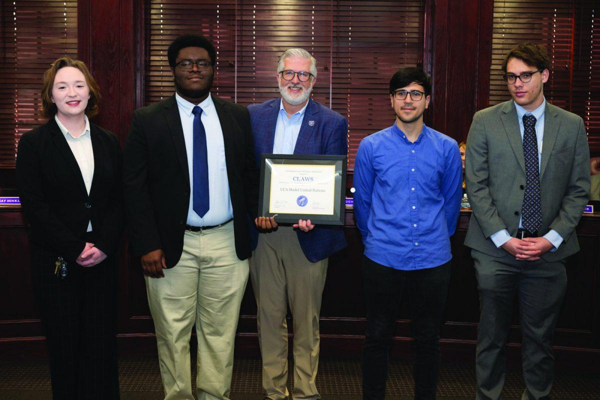 Members of Model UN with UCA President Houston Davis. Model UN was awarded the CLAWS award in Dec. 2024. 