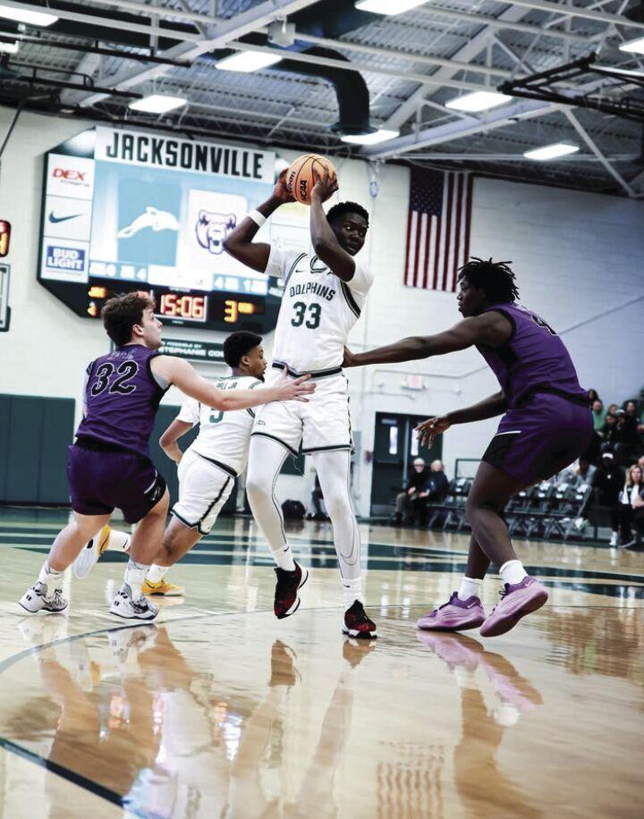 Jacksonville sophomore forward Donovan Rivers weaves his way around UCA freshman guard Layne Taylor and freshman forward Nehemiah Turner. Rivers has scored 48 points in his first season at Jacksonville.