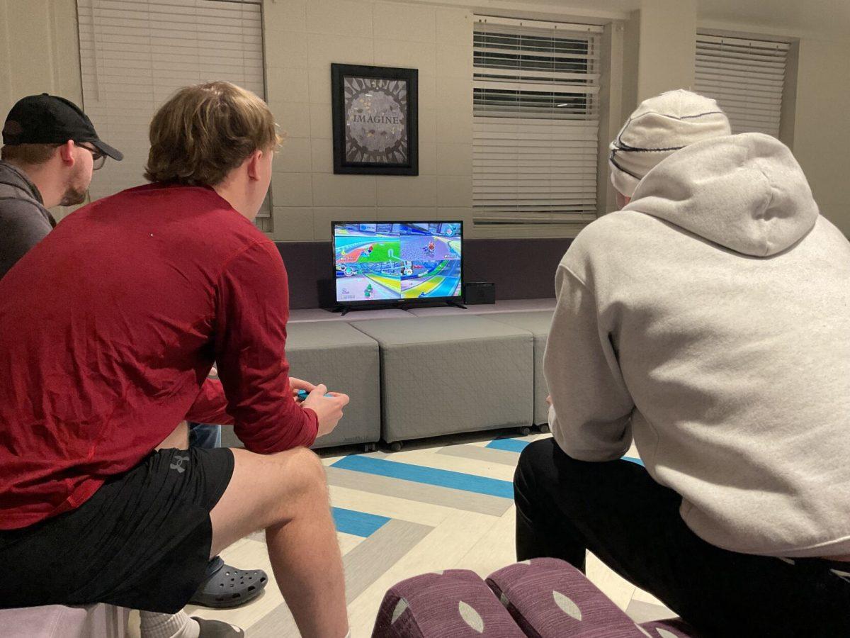 A group of Carmichael Hall residents compete in Mario Kart tournament.  