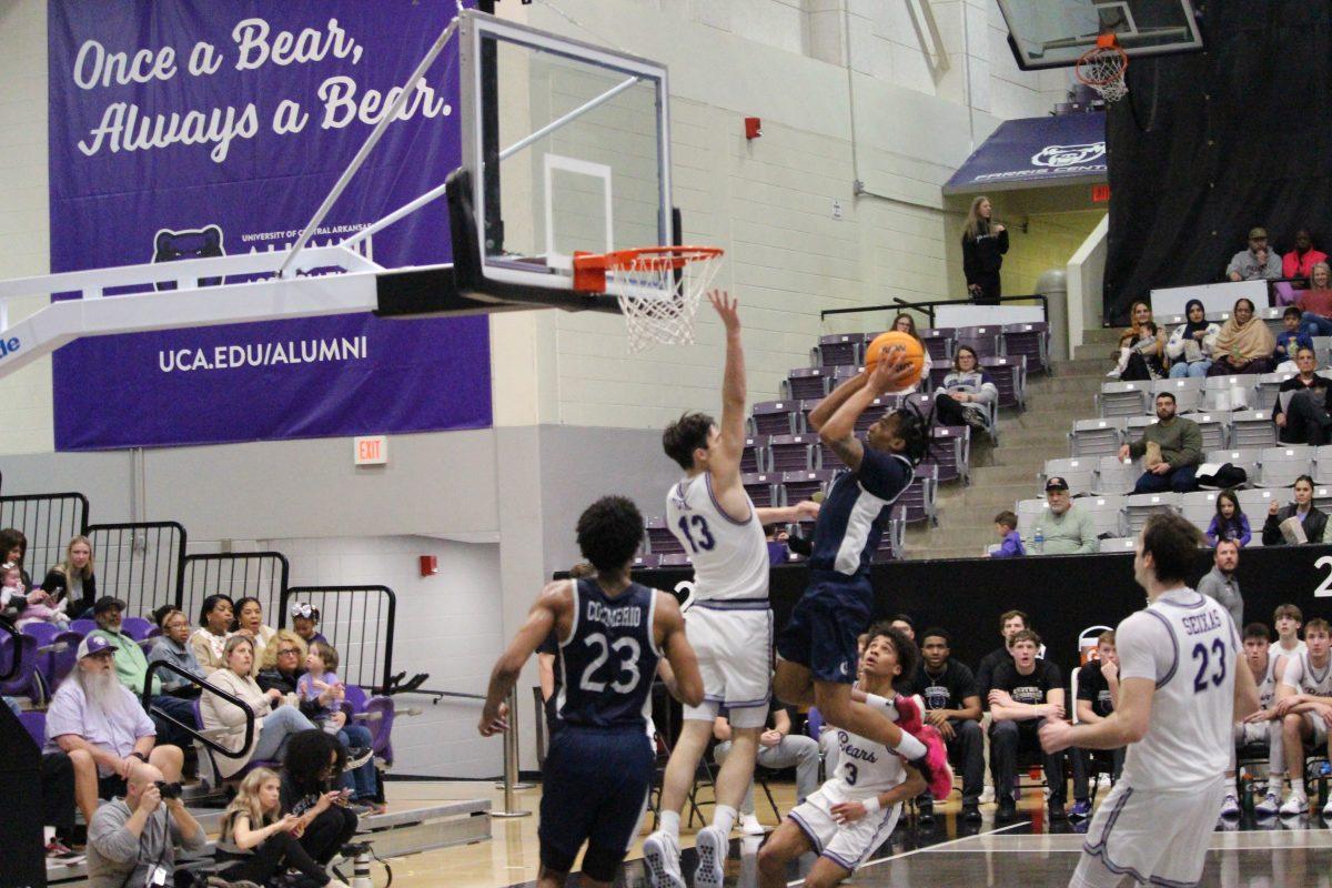 Redshirt freshman guard Ben Fox goes to block a shot attempt from Queens freshman guard DJ Shine. Fox scored two points and had a steal and a block in UCA's loss to the Royals