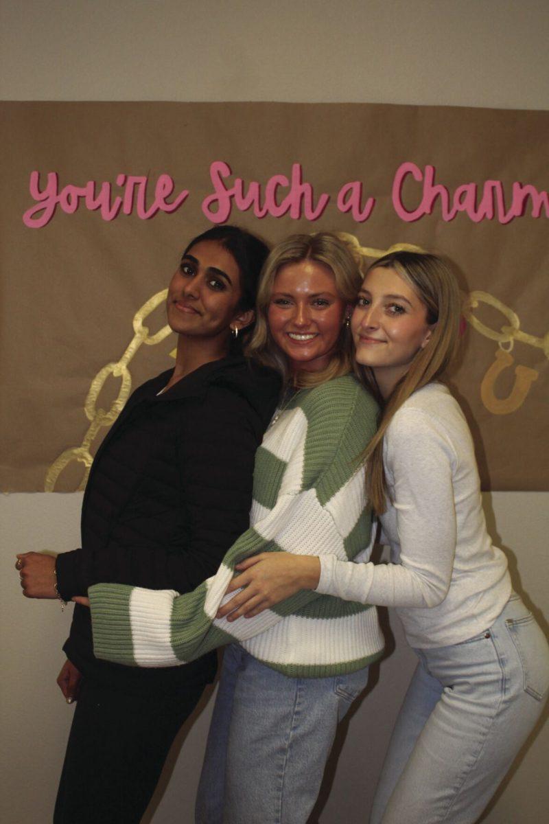 A group of students posing and smiling for a
picture .