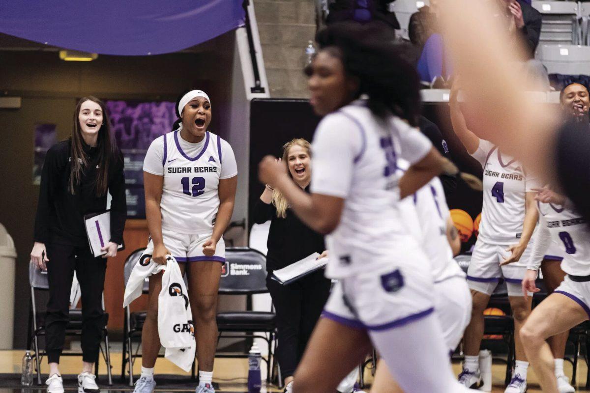 Junior forward Destine Duckworth cheers her teammates on in their 72-59 victory over the Jacksonville University Dolphins. The win secured the Sugar Bears a spot in the ASUN conference championship.