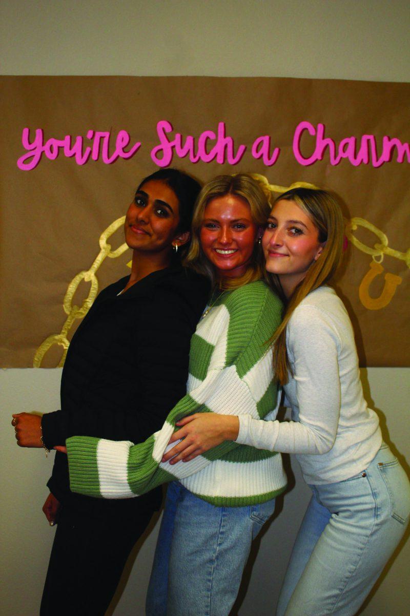 A group of students posing and smiling for apicture .